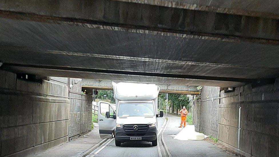 Van under bridge