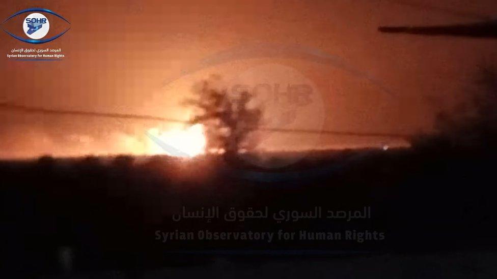 Screengrab of video from the Syrian Observatory for Human Rights purportedly showing an explosion caused by a US military air strike on warehouses in Ayyash, Syria (24 August 2022)