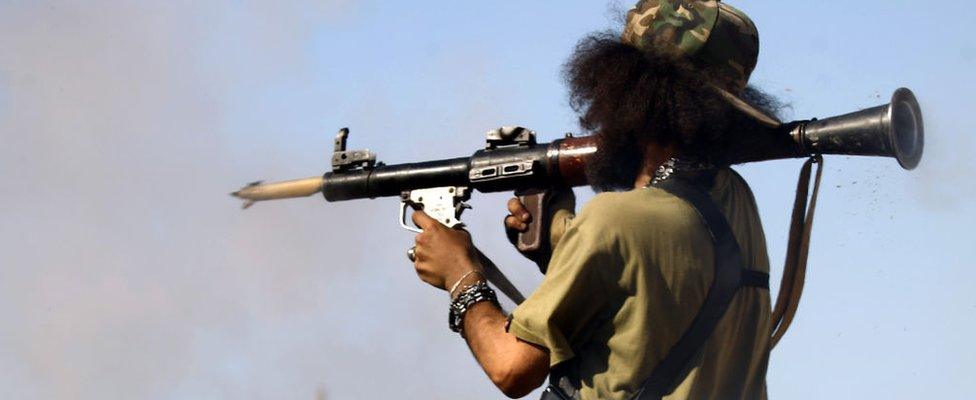 A member of the Libyan National Army (LNA), also known as the forces loyal to Marshal Khalifa Haftar, fires a rocket-propelled grenade during fighting against jihadists in Benghazi's Al-Hout market area on May 20, 2017.