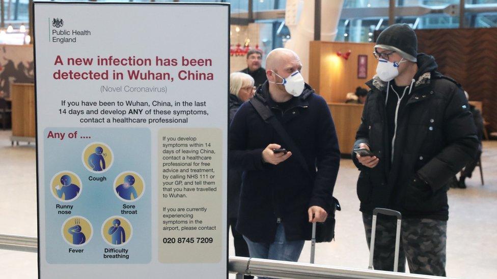 Passengers at Heathrow wearing faces masks