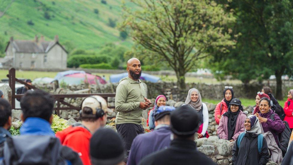 A group of walkers listening to Haroon Mota