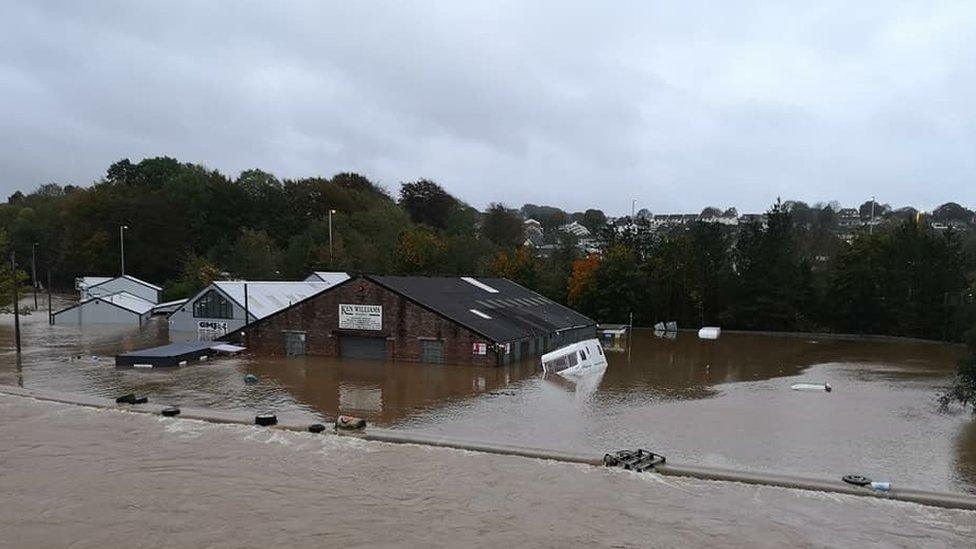 Water submerging a garage and caravans