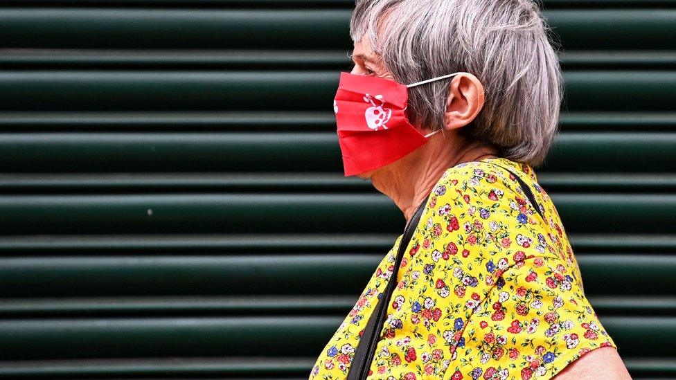 Woman wearing a mask in Leicester