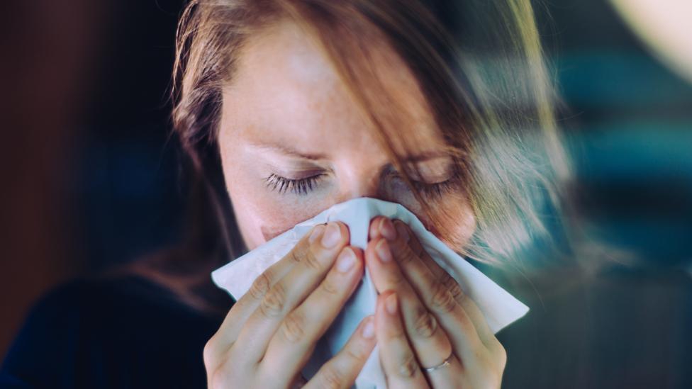 Woman sneezing