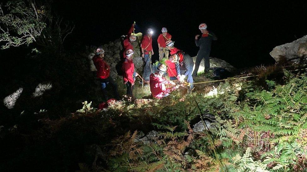 Members of Keswick Mountain Rescue Team rescuing an injured man