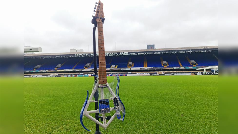 guitar at a football ground