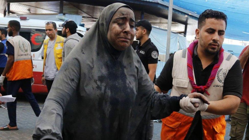 Injured woman brought in to Al-Shifa hospital, 27 October 2023