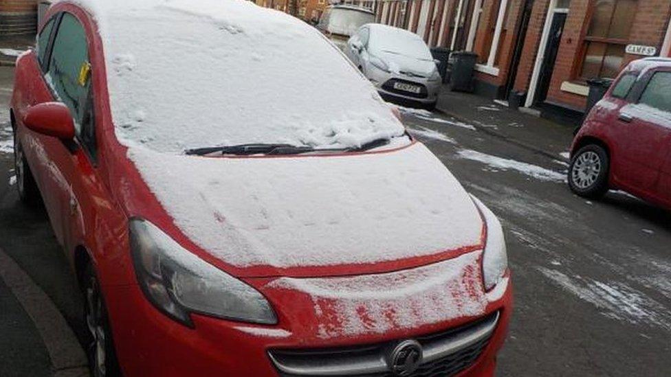 Oliver Claxton's car covered in snow with a parking ticket