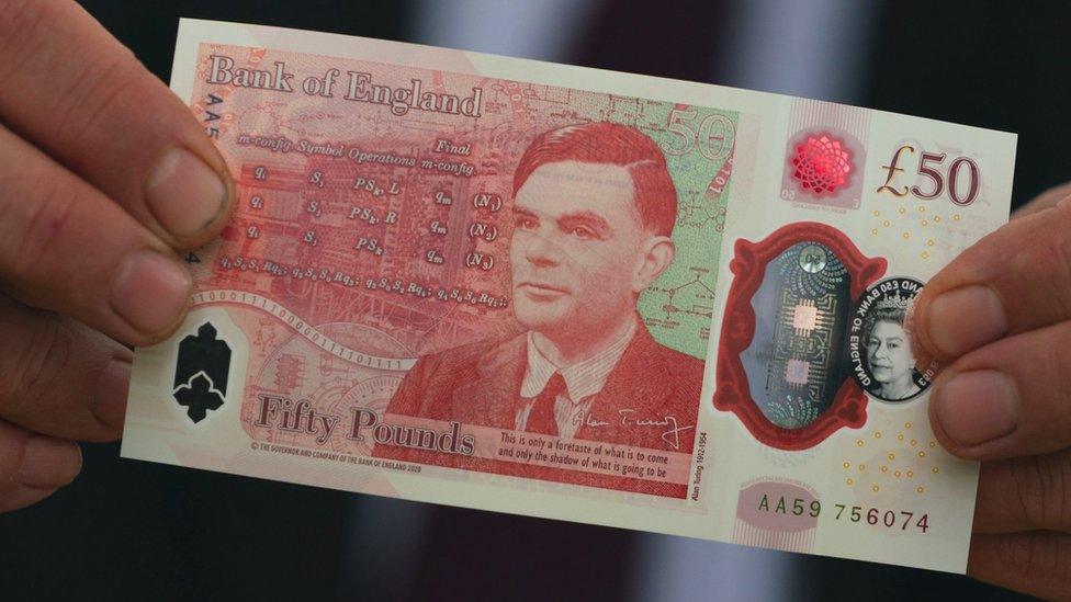 Governor of the Bank of England Andrew Bailey with the new £50 note which features Alan Turing, at Bletchley Park in Milton Keynes.