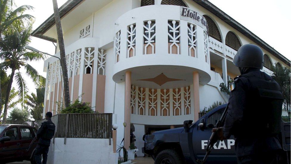 Soldiers stand guard in front of the Etoile du Sud hotel in Bassam,