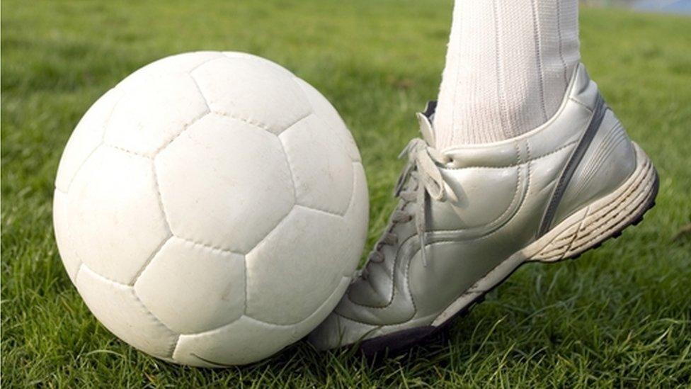 foot kicking a football
