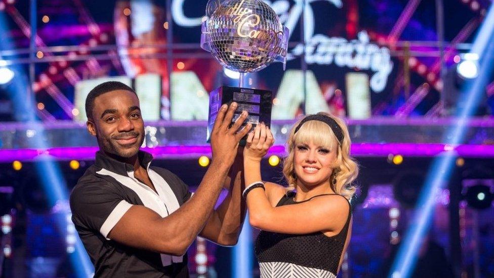 Ore Oduba and Joanne Clifton lifting glitterball trophy