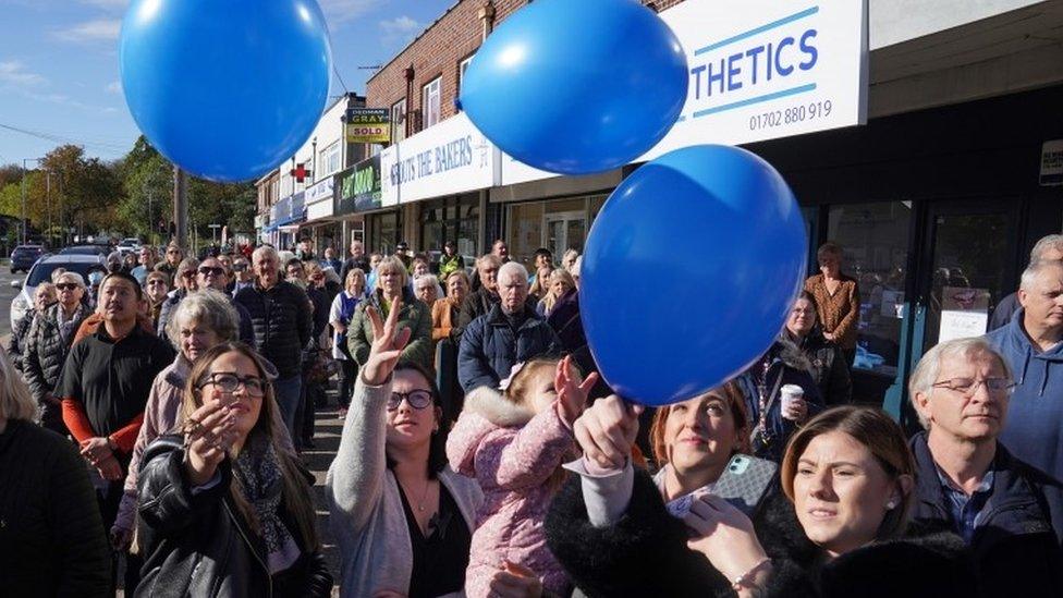 Release of balloons by people observing minute's silence