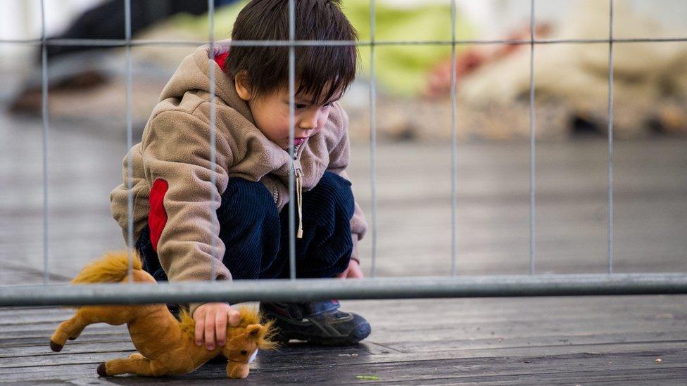 Child plays at a temporary camp in Schaerding, Austria