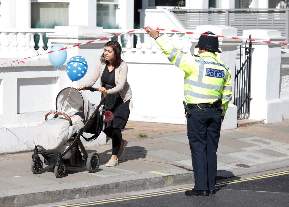 Commuters and workers were led outside a police cordon at the scene