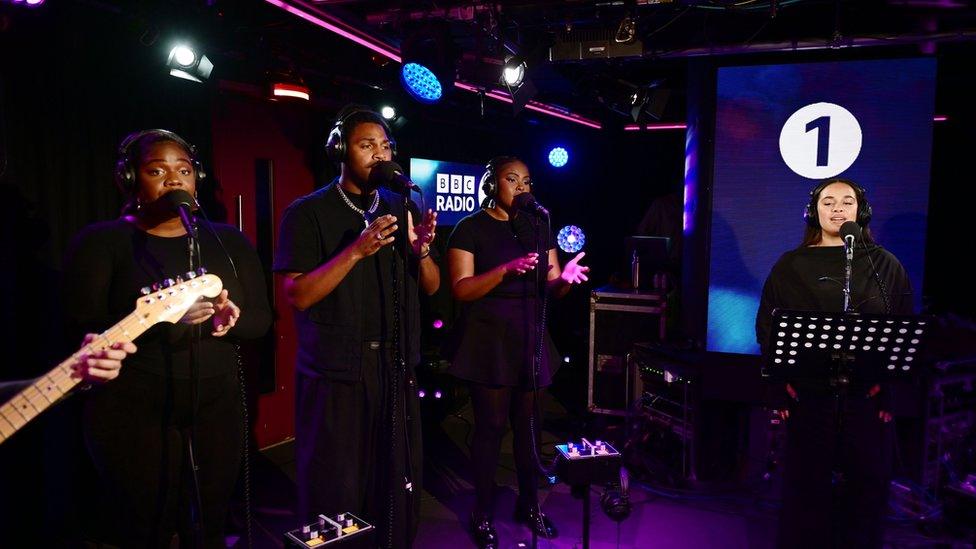 Jorja Smith singing in the Live Lounge with a band