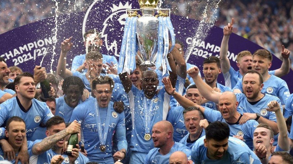 Manchester City players celebrate their Premier League victory at the Etihad Stadium