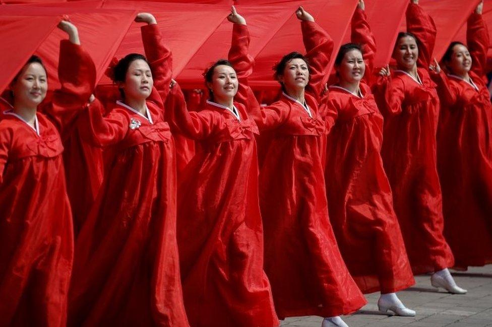 Attendees carry sheets in the colours of North Korea's national flag during a military parade marking the 105th birth anniversary of country"s founding father Kim Il Sung, in Pyongyang April 15, 2017.