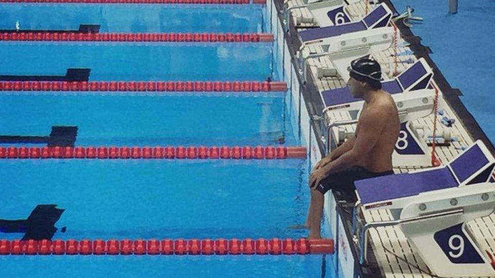 Jesus De Marchena Acevedo sitting on the poolside at Rio