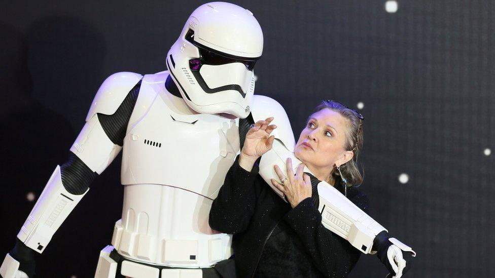 Carrie Fisher poses for cameras as she arrives at the European Premiere of "Star Wars, The Force Awakens" in Leicester Square, London, Britain December 16, 2015