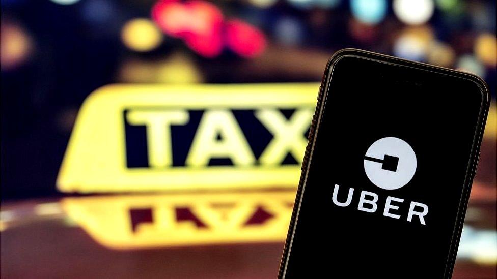 Taxi sign and Uber app