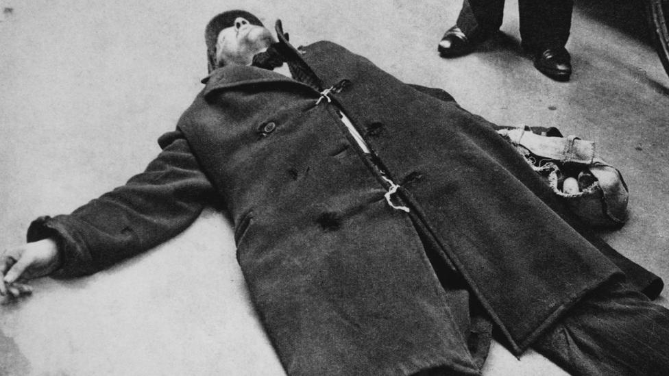 A man collapsed on the street from starvation during the Dutch famine of the winter of 1944-45, Netherlands, circa 1945.