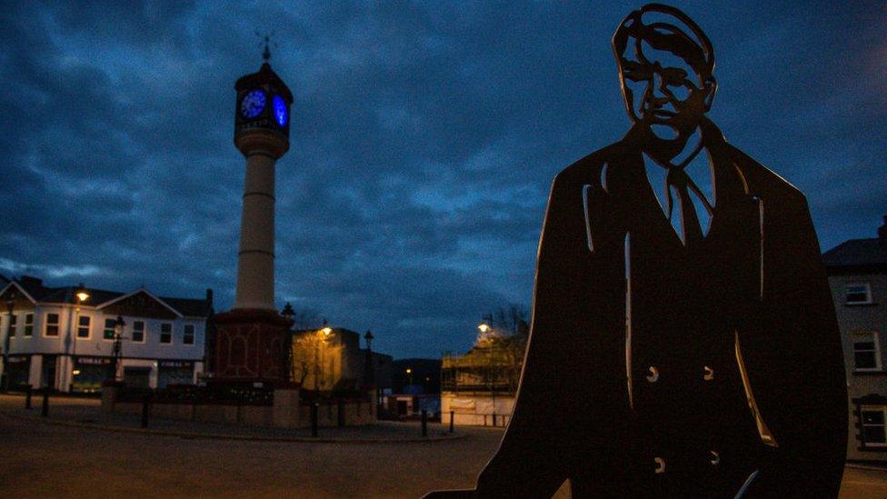 A metal sculpture of Aneurin Bevan, the chief architect of the National Health Service overlooks the the town clock which face was illuminated blue in support of the NHS in the fight against Covid 19 on Thursday April 16, 2020 in Tredegar, Wales.