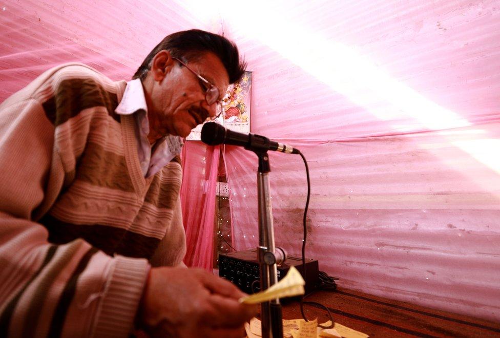 A man makes announcements at a lost and found centre