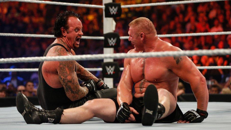 The Undertaker in the ring with Brock Lesnar