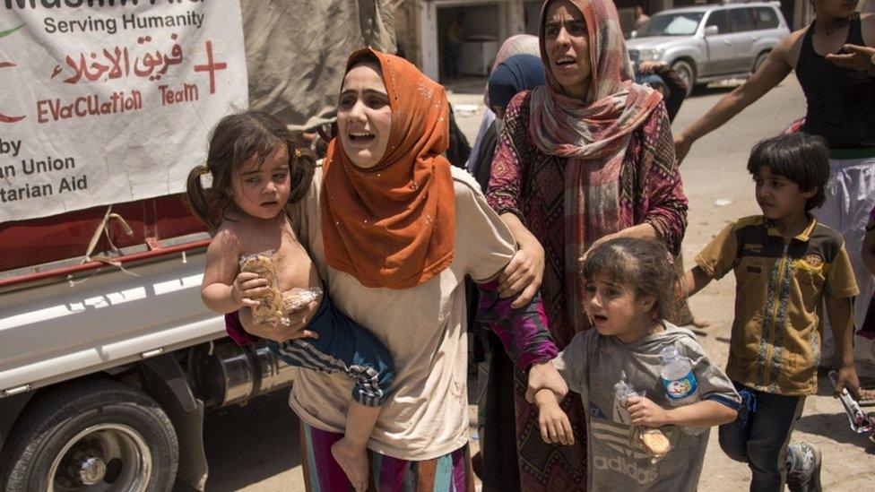 Iraqi women and children fleeing fighting in the Old City of Mosul 8 July 2017