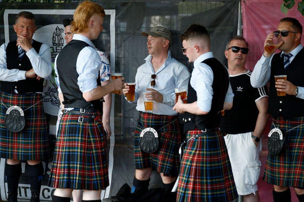 Band members enjoy a pint