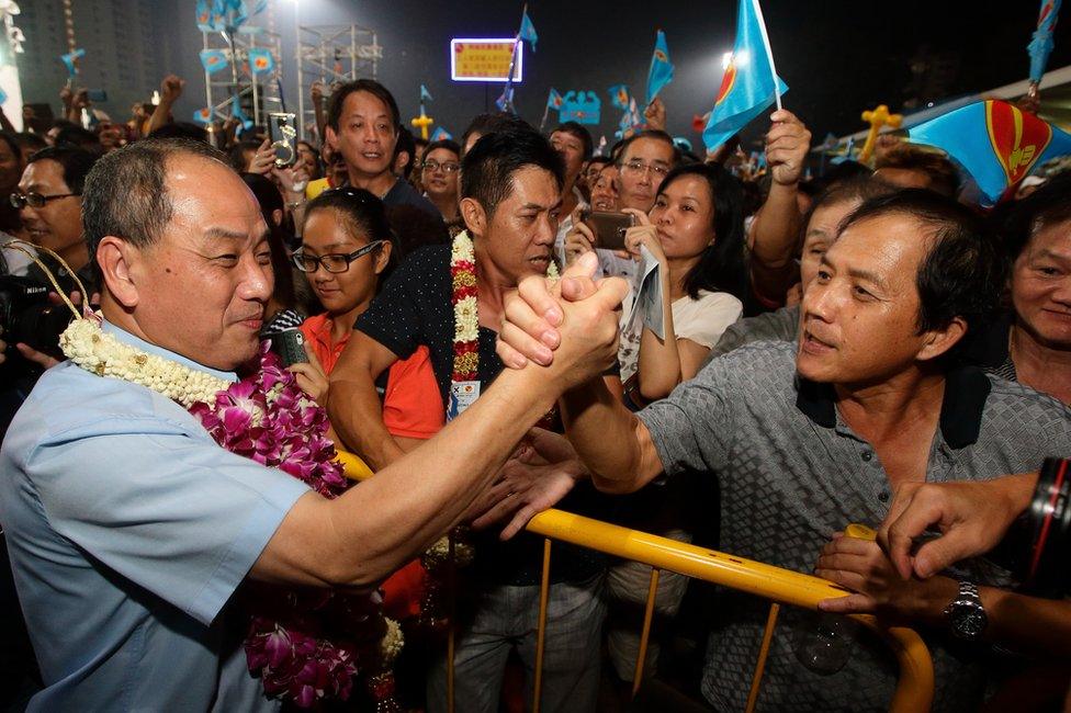 Worker's Party (WP) Secretary General and opposition candidate for the Aljunied Group Representation Constituency (GRC), Low Thia Khiang (L) greets his supporters at the end of his party night rally on the final day of campaigning at Bedok Stadium on 9 September 2015 in Singapore