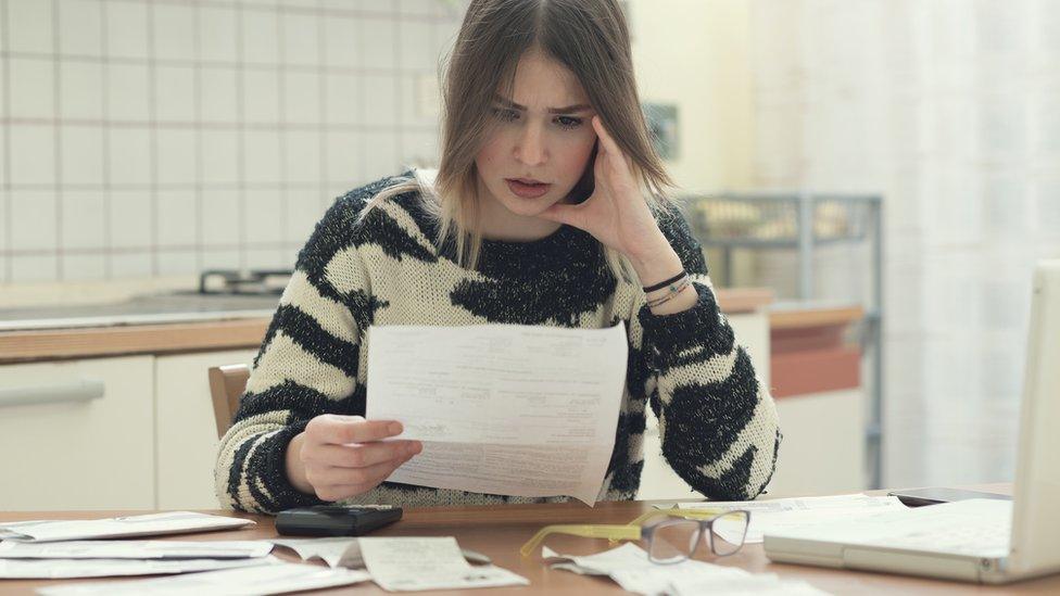 Woman looking at bills