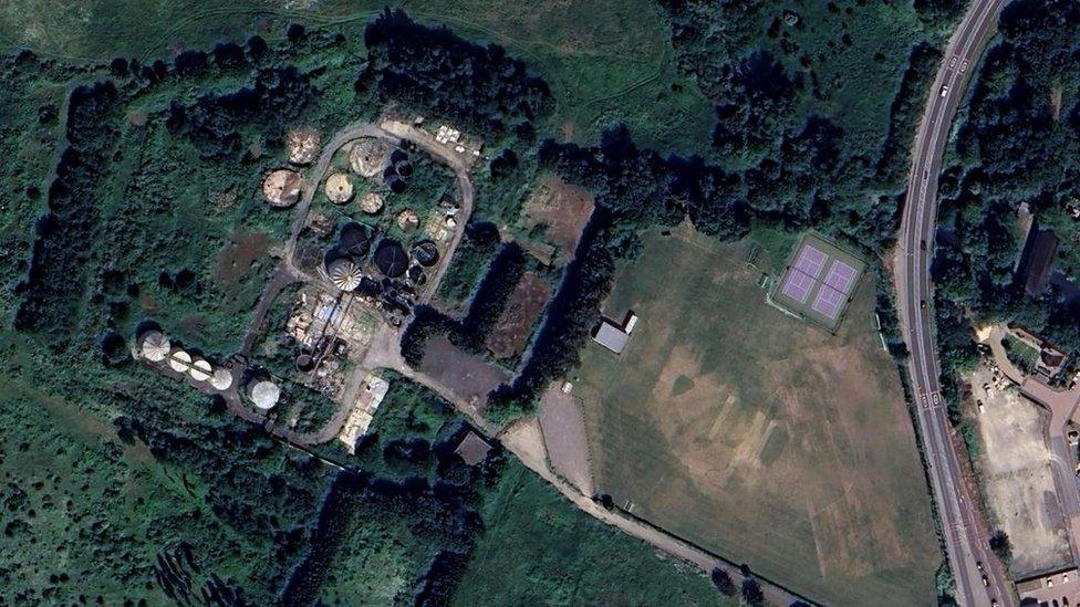 Aerial view of old silos and tanks at a site in Hauxton