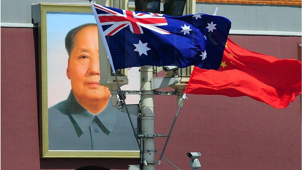 Australian and Chinese flags fly outside the Forbidden City