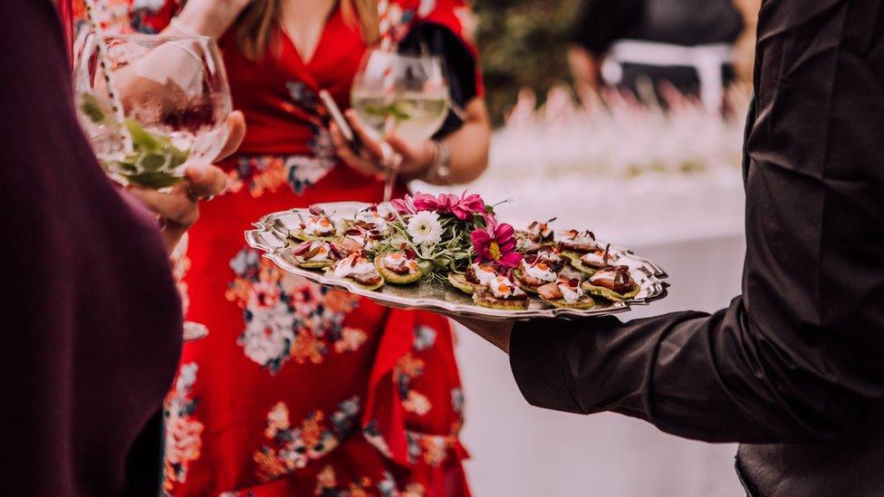 Guests at a wedding eating canapes