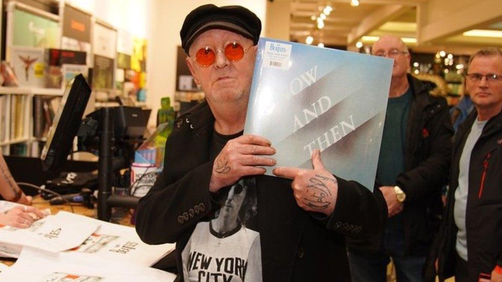 Beatles superfan, John Lennon, who changed his name by deed poll from Alan Williams in April 2022, holds the first copy of the newly released last Beatles song, Now And Then, following a special midnight launch event at HMV Liverpool