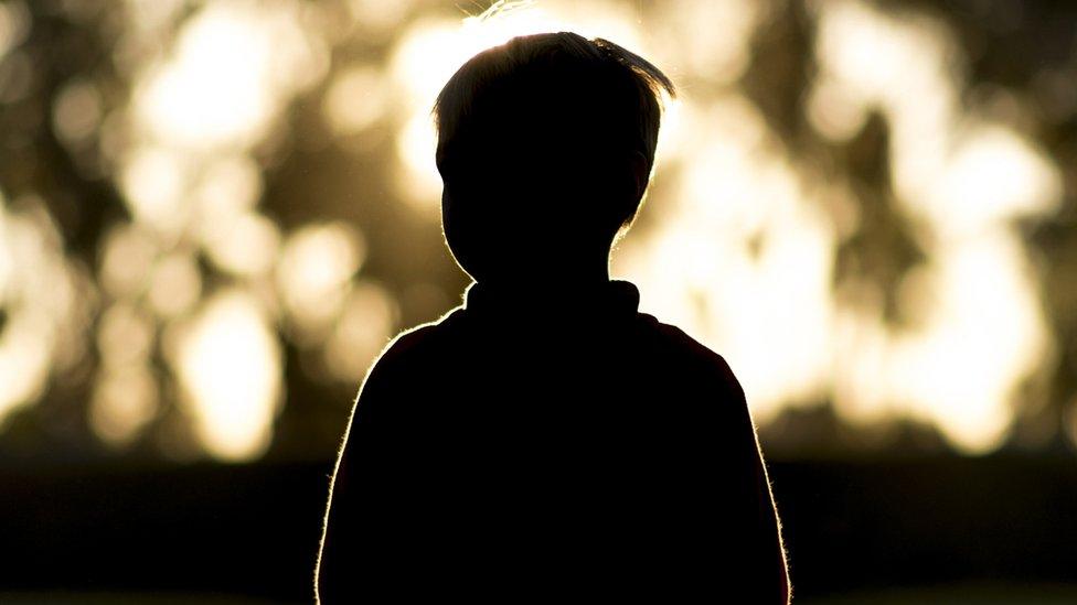 A silhouette of a child