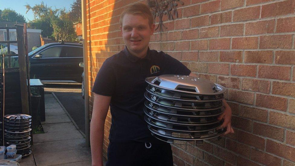 Matthew holding hubcaps