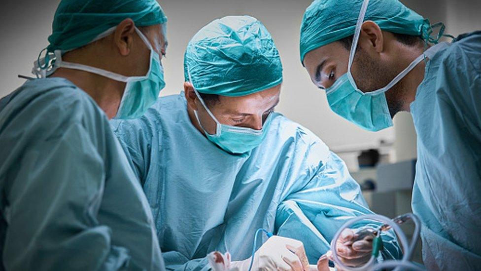 Doctors carrying out plastic surgery procedures