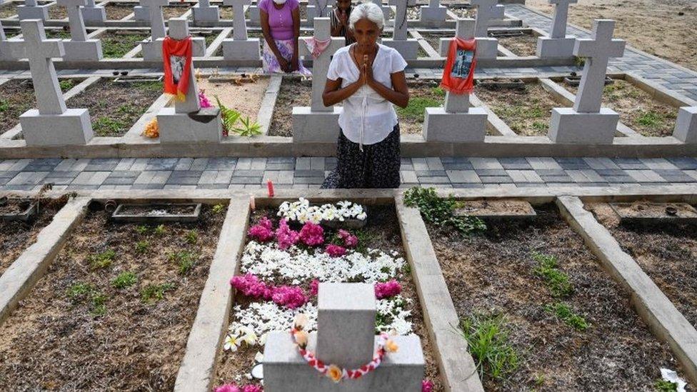 Relatives pay their respects outside St Sebastian's Church