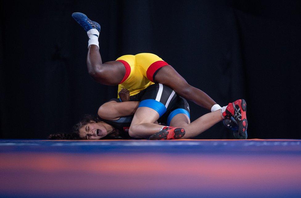 A handout photo made available by the OIS/IOC shows Zaineb Sghaier of Tunisia (blue) in action against Natacha Veronique Nabaina of Cameroon (yellow) in the Wrestling Women"s Freestyle 65kg Group B at the Asia Pavilion, Youth Olympic Park during The Youth Olympic Games, Buenos Aires, Argentina, 13 October 2018.