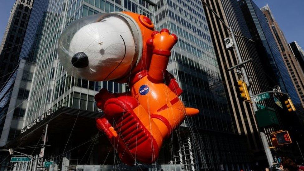 Astronaut Snoopy flies during the parade