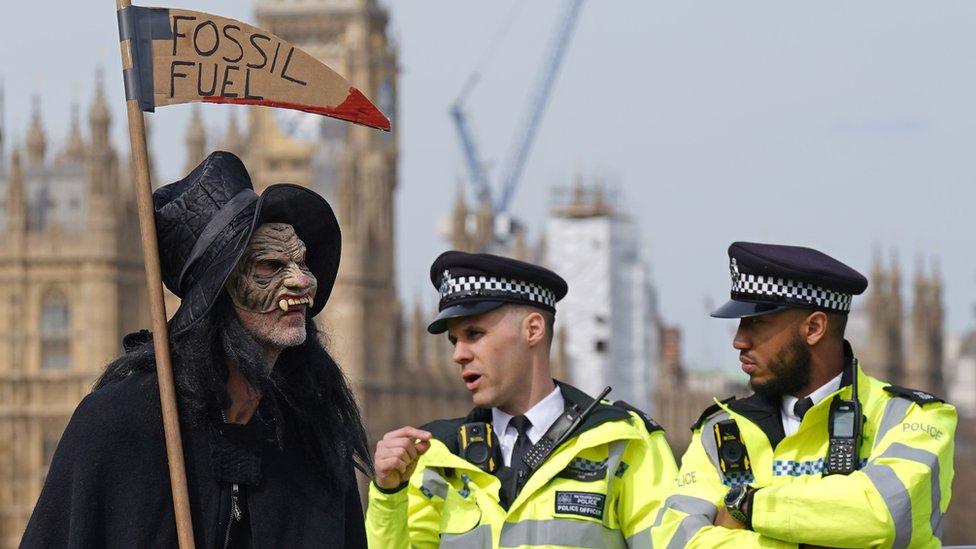 Protester and police on Lambeth Bridge