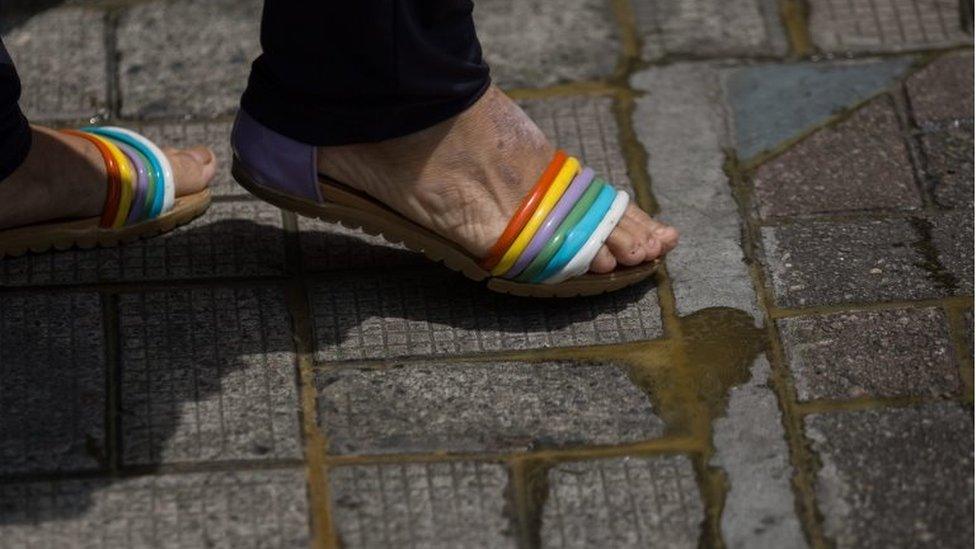 A woman walks on pavement glued together with epoxy in a security area where Chinese state leader Zhang Dejiang will reside and deliver a speech during his 3-day visit in Hong Kong, China, 16 May 2016