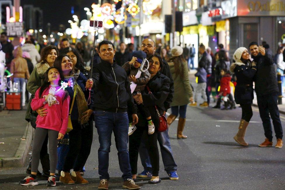 A family takes a selfie on the Golden Mile in Leicester during Diwali celebrations