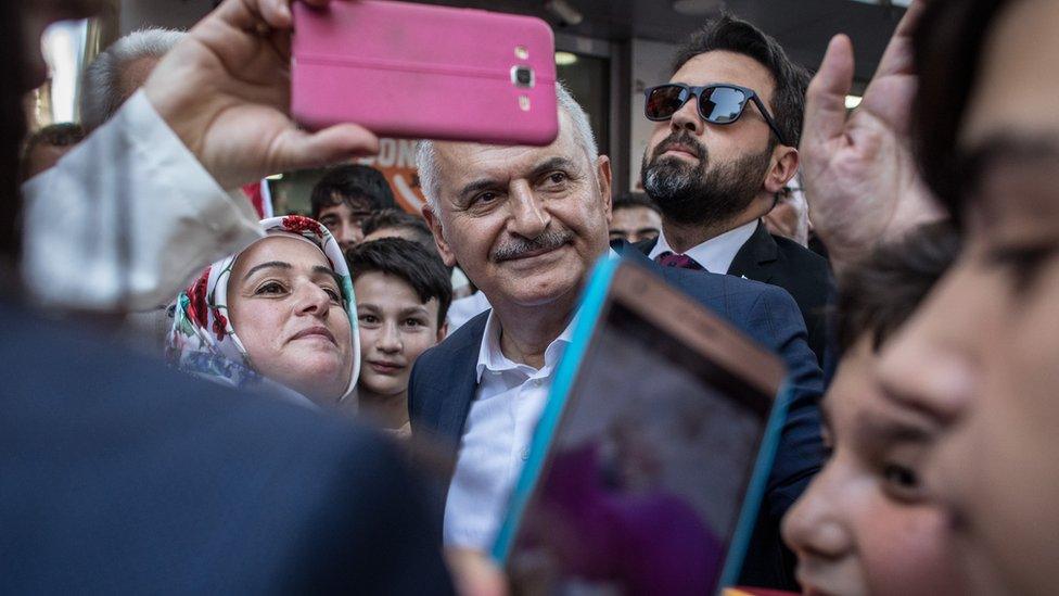 Binali Yildirim of the ruling Justice and Development Party (AKP) meets with supporters during a campaign street stop on June 18, 2019 in Istanbul