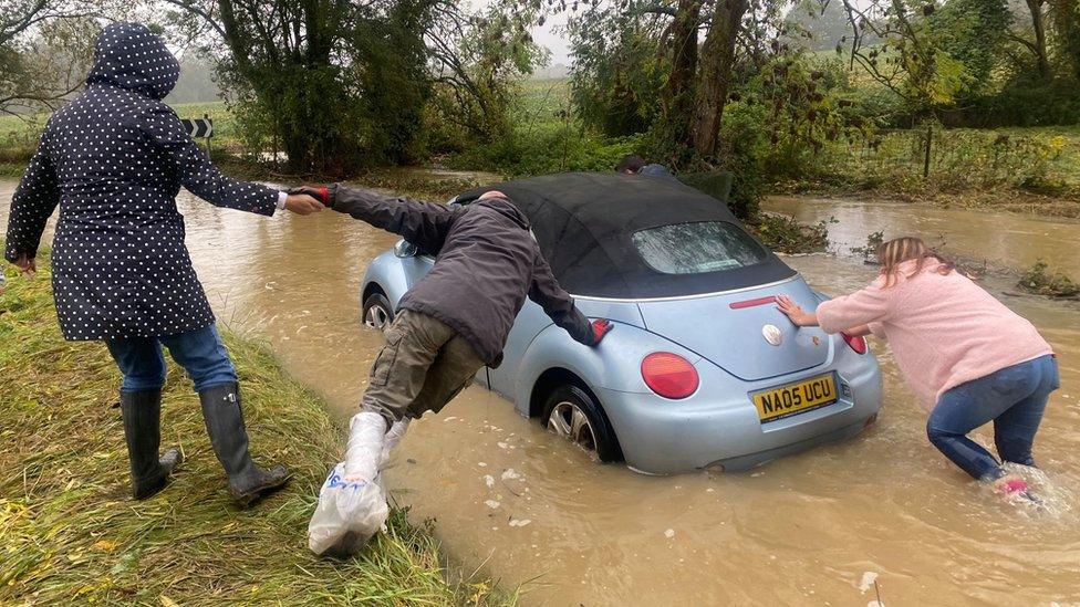 Shannon Eustace pushing her car with assistance