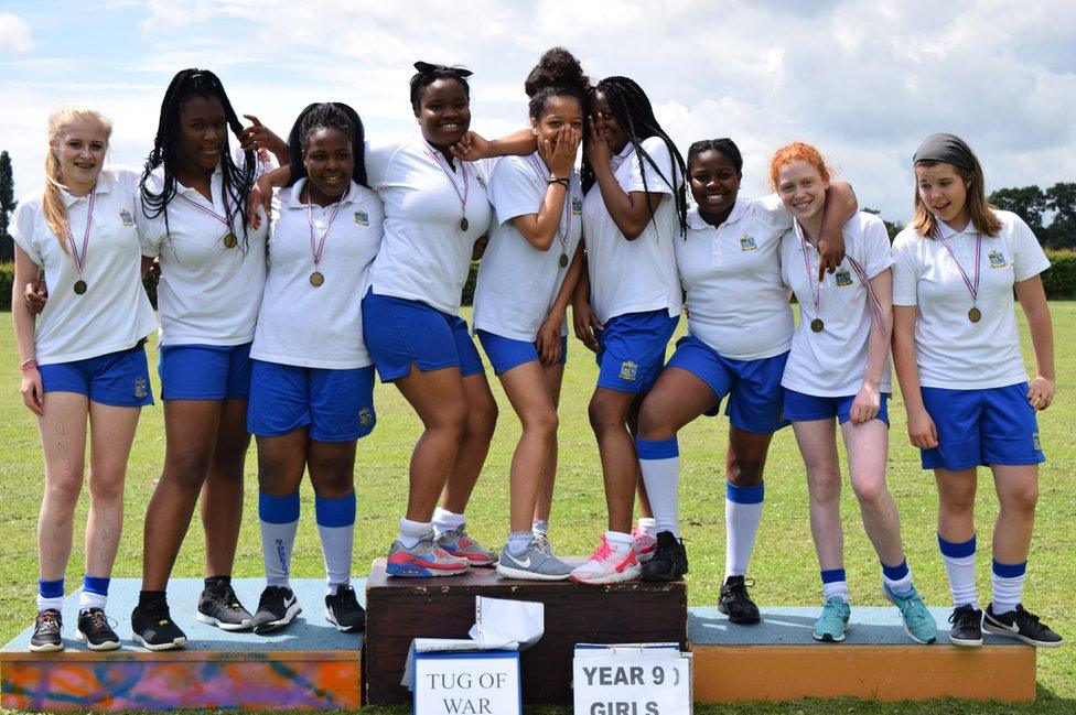 Girls standing on a podium