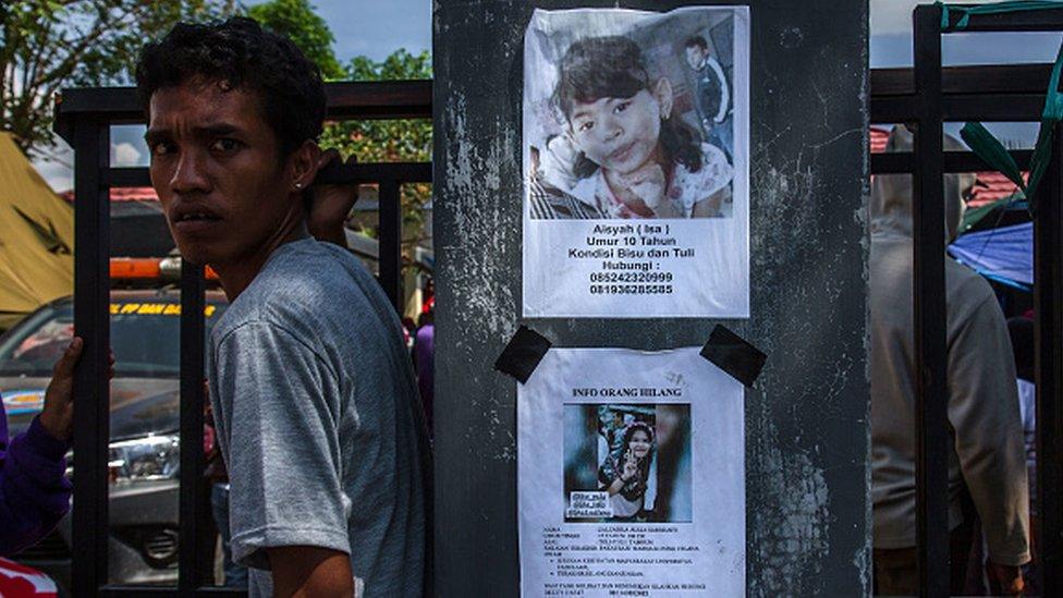 Photographs of missing people were displayed on the wall